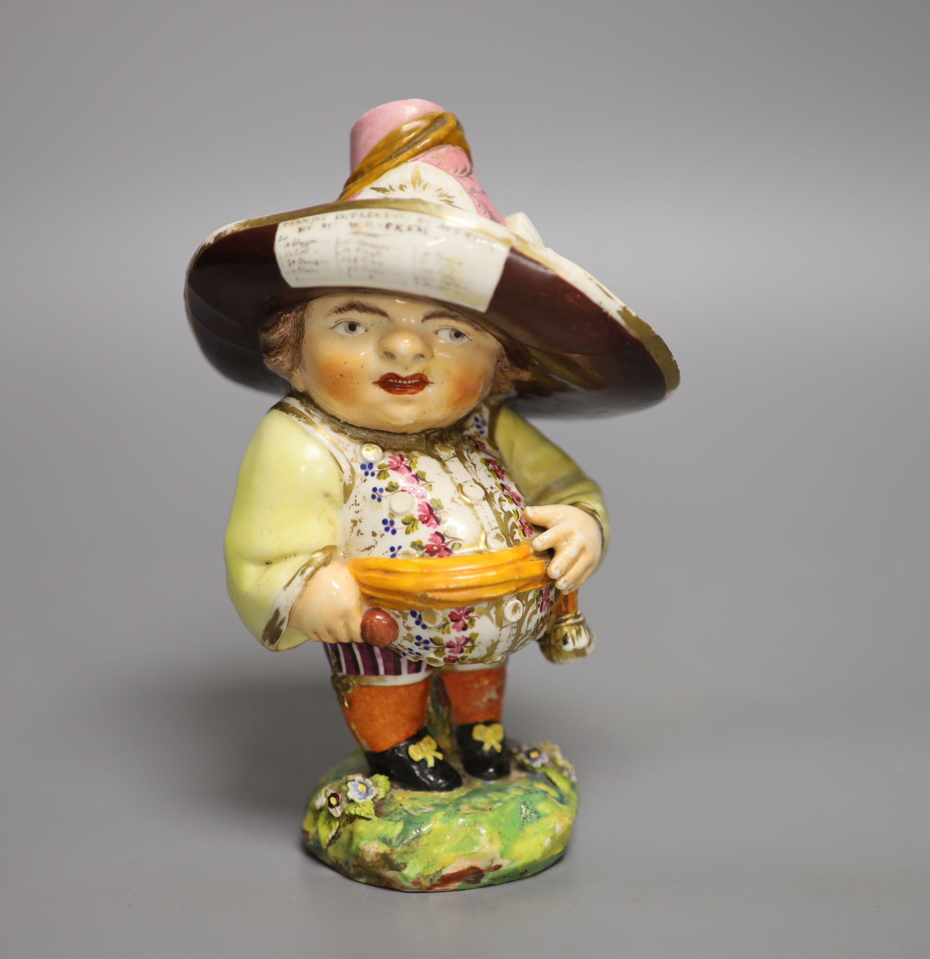 A Derby model of a Mansion Dwarf, modelled as a portly man wearing a large brimmed hat with a menu on it, c.1815 , height 18cm